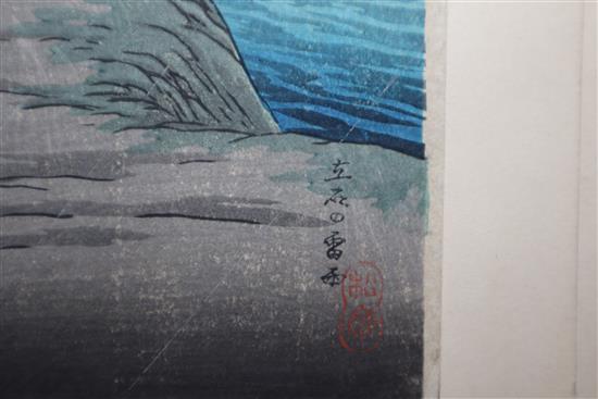 Japanese School, pair of woodblock prints, Travellers in stormy weather, 38 x 17cm, unframed